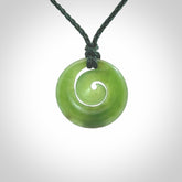 Hand carved New Zealand Kawakawa jade koru pendant. Carved for NZ Pacific by Ross Crump. Jade jewelry for sale online exclusively with NZ Pacific.